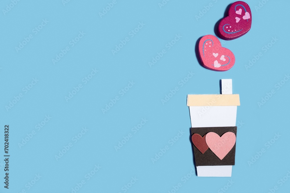 Paper handmade coffee cup with hearts on a pastel blue background. Concept for Valentine's Day, Mother's Day, World Women's Day. Romantic flat composition. Paper handmade coffee cup with hearts on a pastel blue background. Concept for Valentine's Day, Mother's Day, World Women's Day. Romantic flat composition.