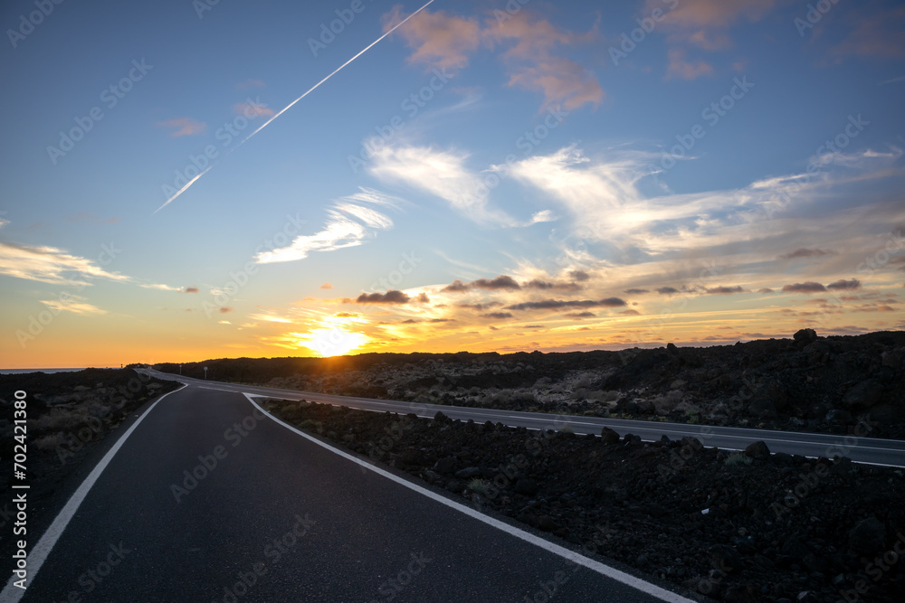 Road, lava field and a sunset, Lanzarote, Spain