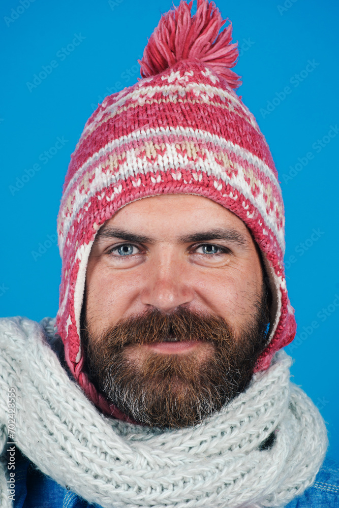 Men winter fashion. Closeup portrait of smiling man in knitted scarf and hat. Fashion accessories for winter. Handsome trendy man in winter hat and scarf. Fashionable bearded male in winter clothes. Men winter fashion. Closeup portrait of smiling man in knitted scarf and hat. Fashion accessories for winter. Handsome trendy man in winter hat and scarf. Fashionable bearded male in winter clothes.