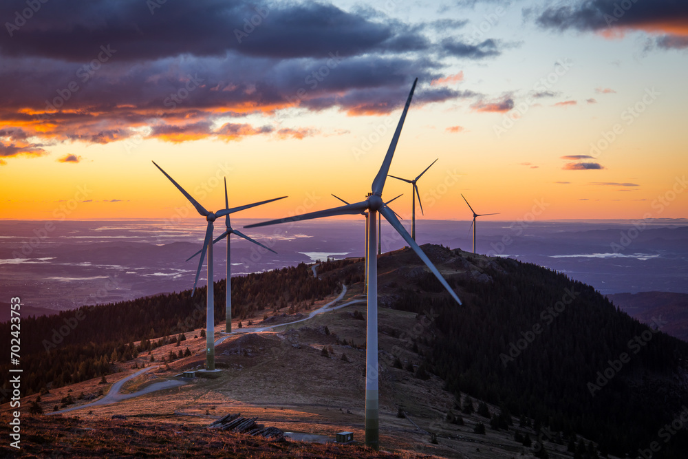 A group of wind power plants early in the morning while sunrise in Austria - obrazy, fototapety, plakaty 