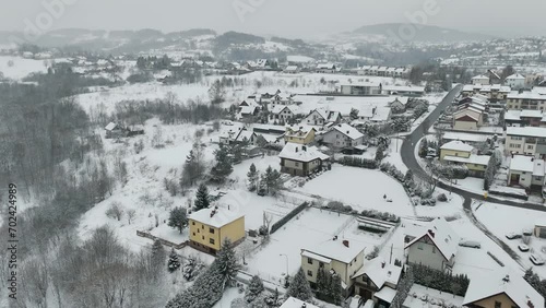 Limanowa, Poland - Aerial drone footage of residential houses in European town covered with snow photo