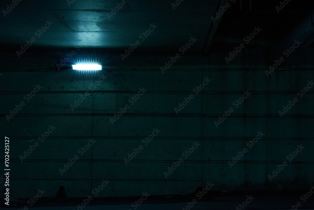 front view of dark tunnel with blue light, no people