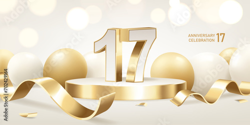 17th Anniversary celebration background. Golden 3D numbers on round podium with golden ribbons and balloons with bokeh lights in background.