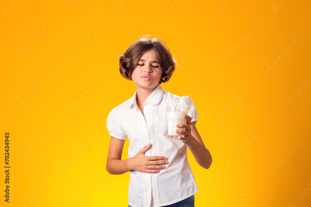 Girl with glass of milk feeling stomach pain. Dairy Intolerant person. Lactose intolerance, health care concept. Girl with glass of milk feeling stomach pain. Dairy Intolerant person. Lactose intolerance, health care concept.