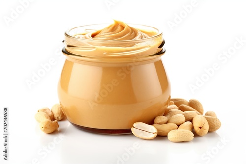 Glass jar with peanut butter on white background photo
