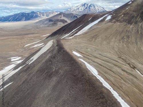 The Valley of Ten Thousand Smokes in Katmai National Park and Preserve in Alaska is filled with ash flow from Novarupta eruption in 1912. Aerial view of ash filled valley between mountains. photo