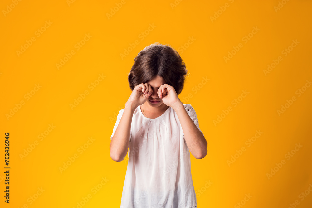 Sad kid girl over yellow background. Frustration concept Sad kid girl over yellow background. Frustration concept