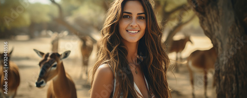 Young spanish girl in wild nature with animals blured in background. photo