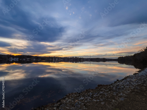 Obraz na płótnie Beautiful lake with reflections in the water at sunset with spectacular colors. landscape photography w salonie