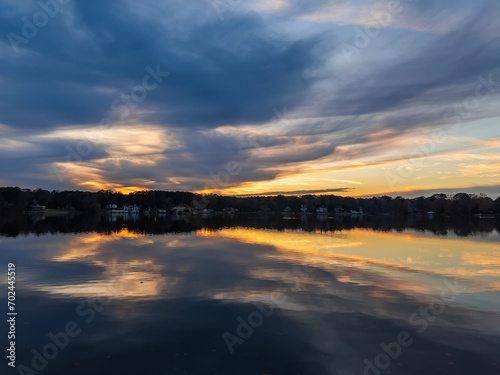 Obraz na płótnie Beautiful lake with reflections in the water at sunset with spectacular colors. landscape photography w salonie