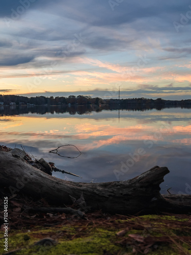 Obraz na płótnie Beautiful lake with reflections in the water at sunset with spectacular colors. landscape photography w salonie