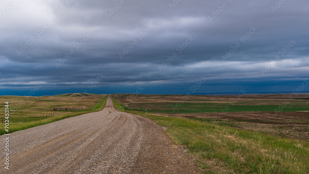 Storm over horizon with road, Alberta, Caada