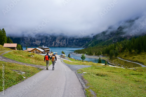 Hikers and trail to Oeschinen lake, a UNESCO site, Kandersteg Switzerland 