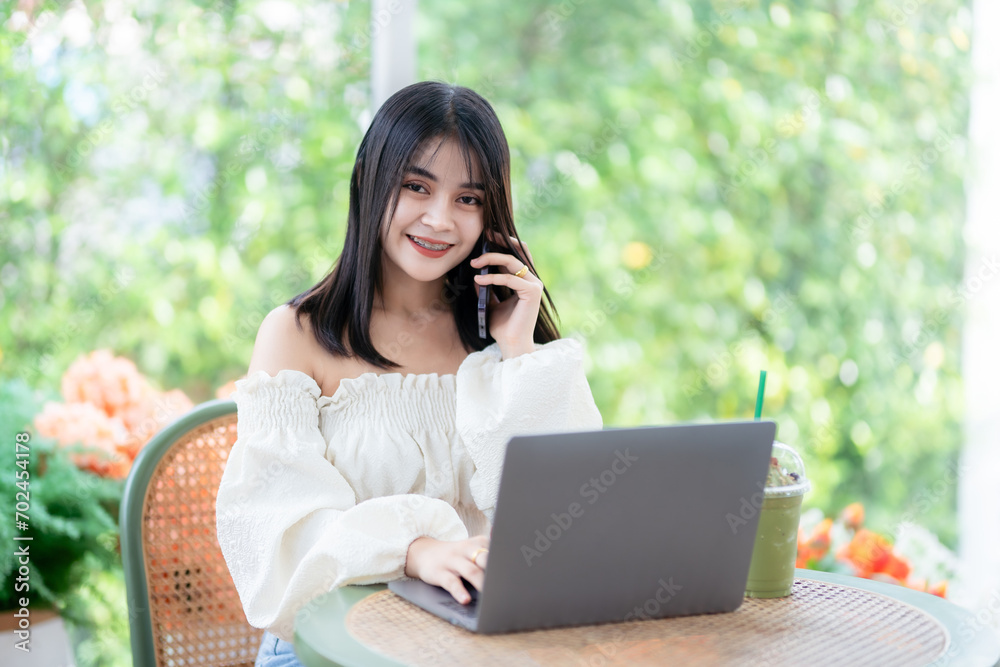 Happy of asian freelance people business female talking making using smartphone casual working with laptop computer and coffee cup in at the cafe, Business Lifestyle communication concept