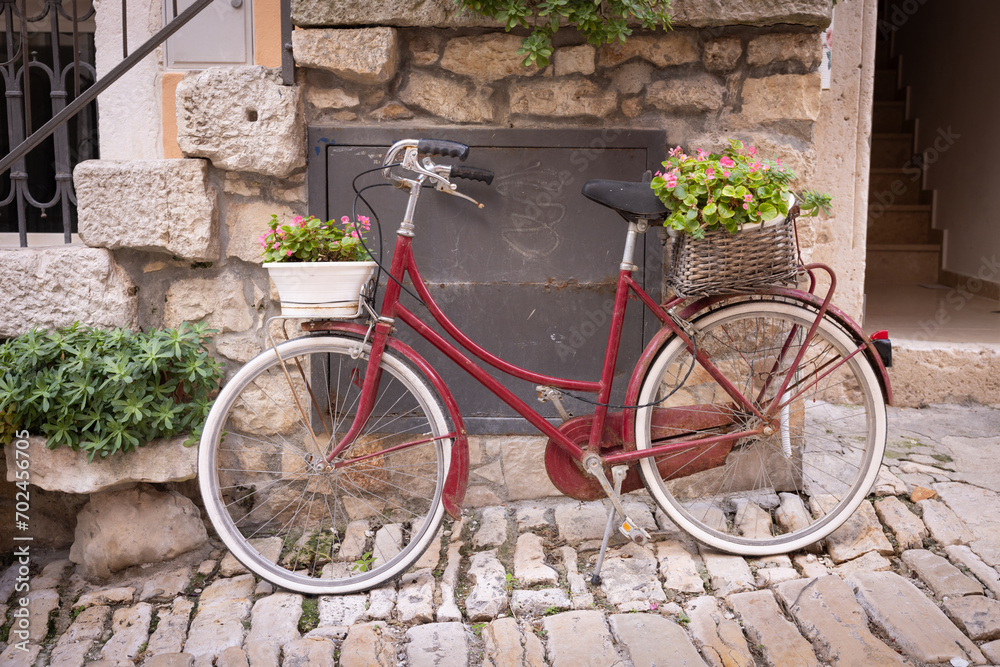The old city of Rovinj, Istria peninsula, Croatia. A bicycle in the historic center with flowers in baskets.