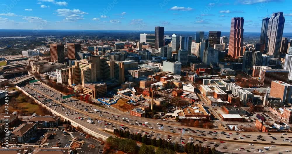Multiple cars in the road going around the city downtown. Splendid view of Atlanta from aerial perspective.