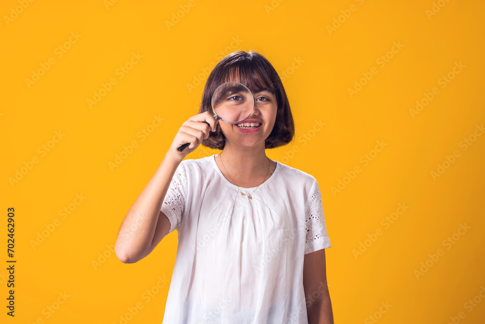 Girl holding magnifier in hand. Education and curiosity concept Girl holding magnifier in hand. Education and curiosity concept