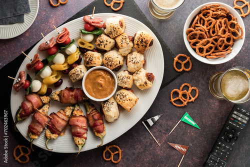 A platter of game day appetizers with beer and pretzels. photo