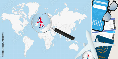 United Kingdom is magnified over a World Map, illustration with airplane, passport, boarding pass, compass and eyeglasses. photo