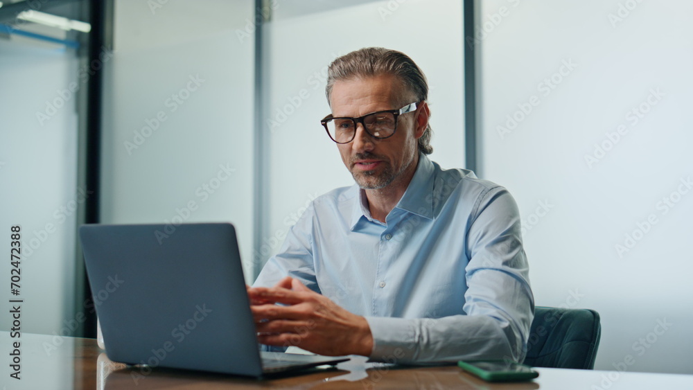 Happy businessman computer videocalling cabinet close up. Smiling boss talking Happy businessman computer videocalling cabinet close up. Smiling boss talking