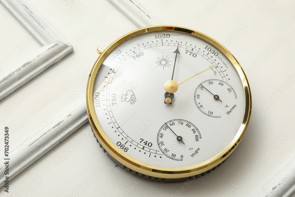 Aneroid barometer on white wooden background Aneroid barometer on white wooden background
