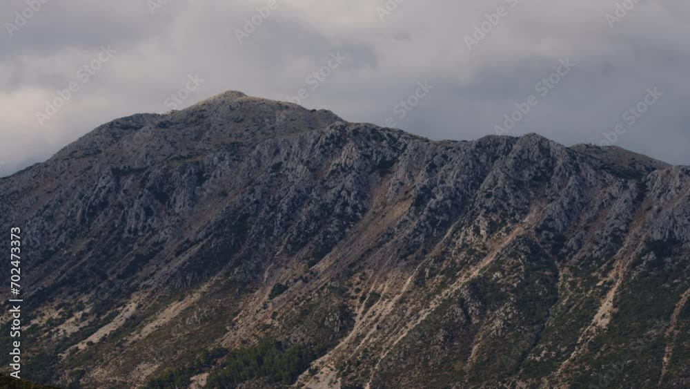Timelapse of dramatic clouds passing over a mountaintop near Vasiliki bay, Lefkada, Greece on a summer day. Weather and environment concept. Timelapse of dramatic clouds passing over a mountaintop near Vasiliki bay, Lefkada, Greece on a summer day. Weather and environment concept.