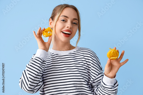 Young woman with raw pasta ...