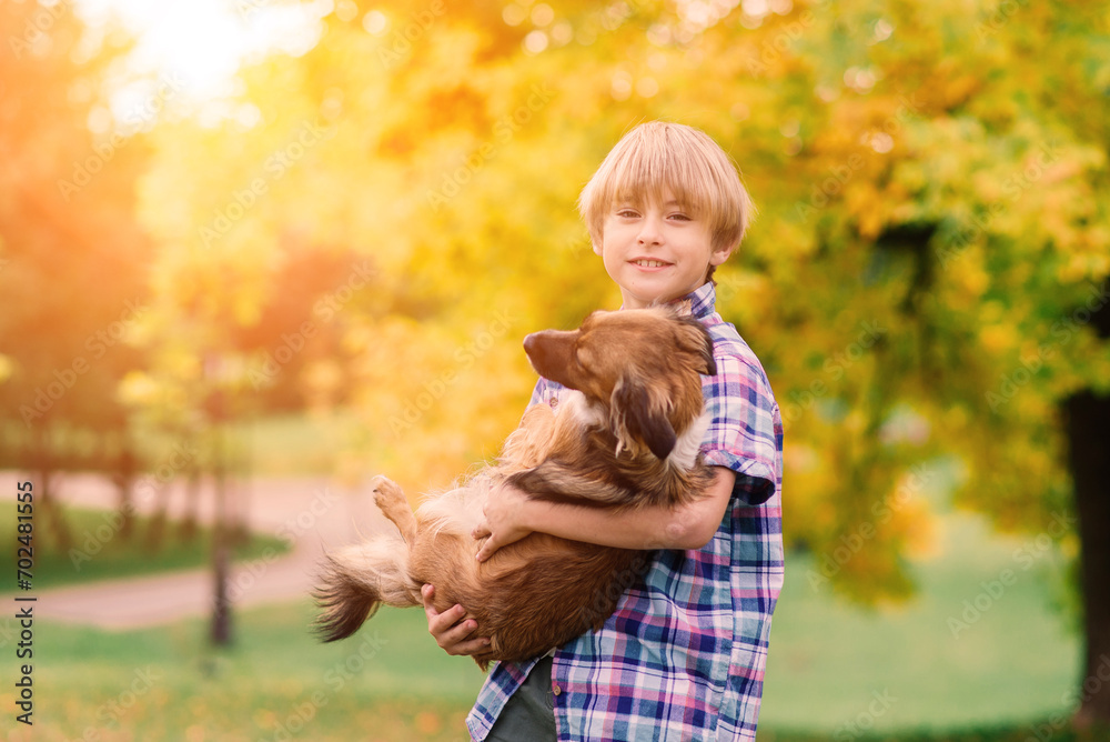 Cute boy playing and walking with his dog in a meadow. Cute boy playing and walking with his dog in a meadow.