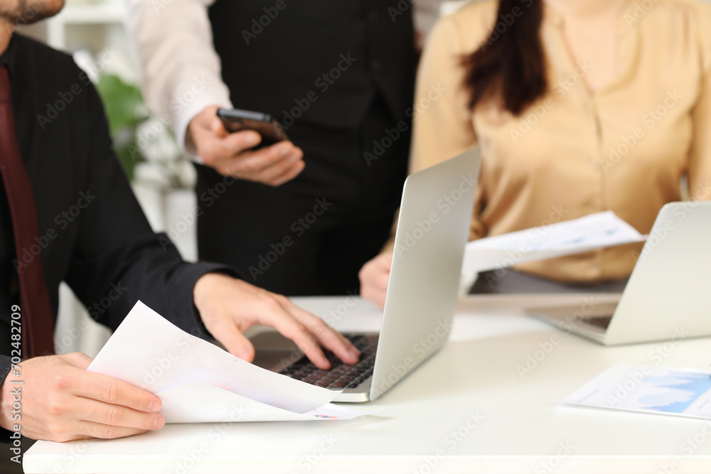 Business consultants working at table in office, closeup Business consultants working at table in office, closeup
