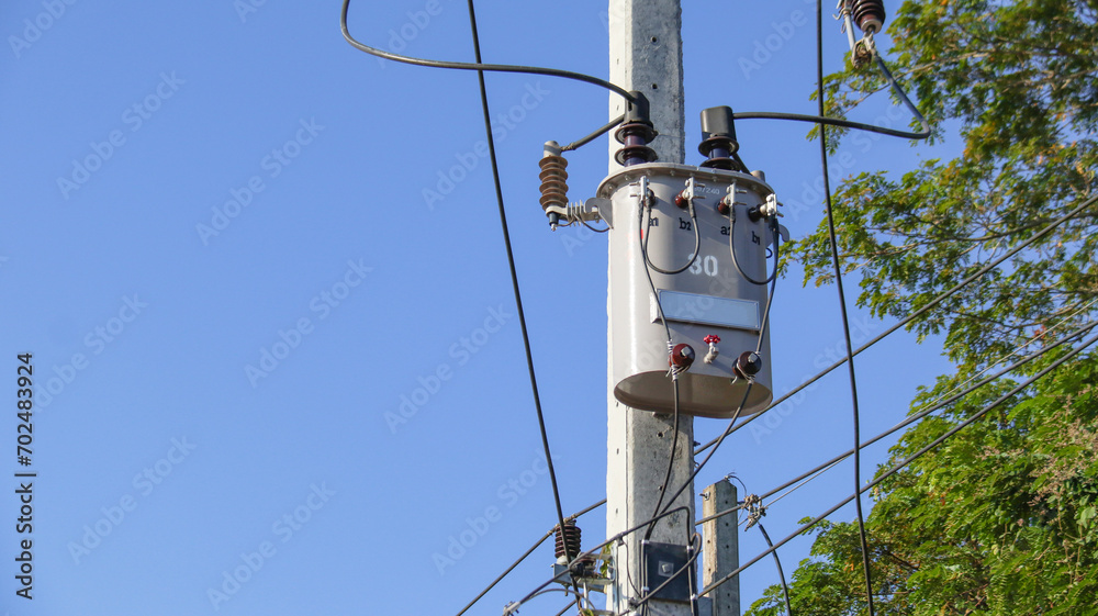Gray power transformer installed on concrete pole Gray power transformer installed on concrete pole