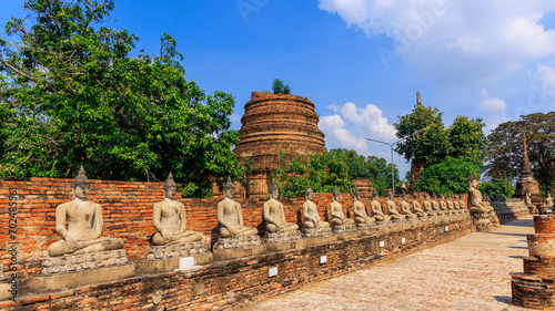 Row of Buddha statues at historic Wat Yai Chai Mongkhon temple in Ayitthaya, Thailand. photo
