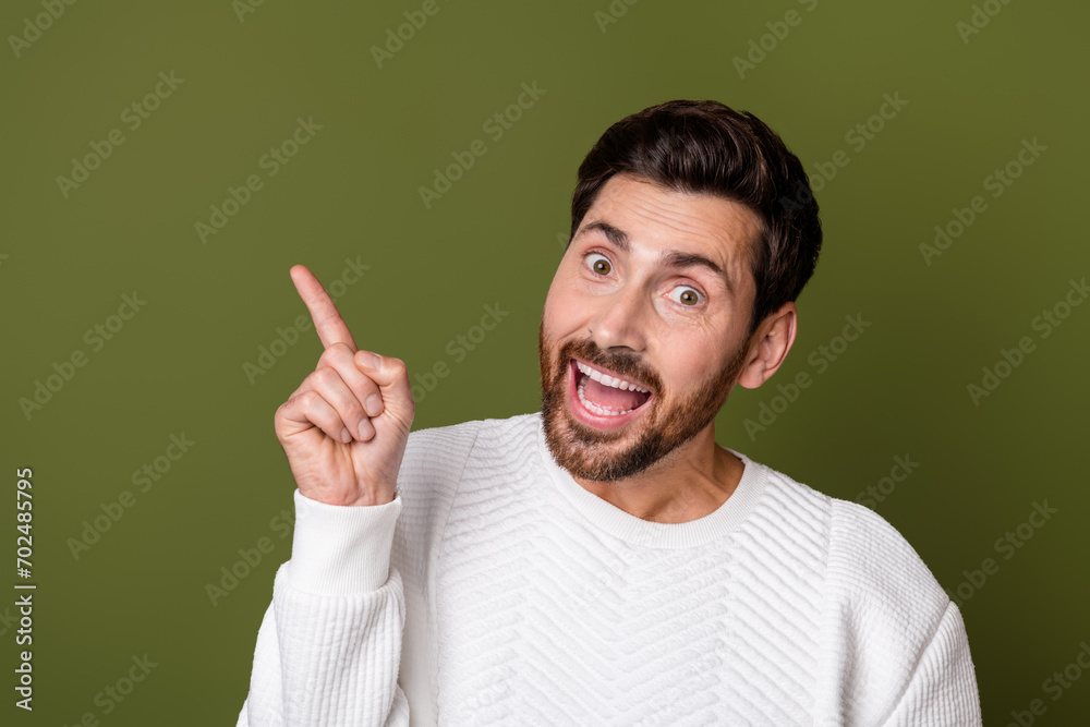 Photo of cheerful satisfied man dressed trendy white clothes presenting information mockup empty space isolated on khaki color background Photo of cheerful satisfied man dressed trendy white clothes presenting information mockup empty space isolated on khaki color background