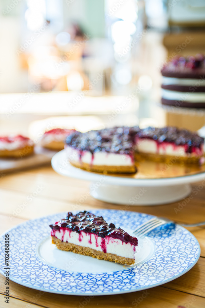 Cheesecake with winter berry forest fruits, serving slices Cheesecake with winter berry forest fruits, serving slices