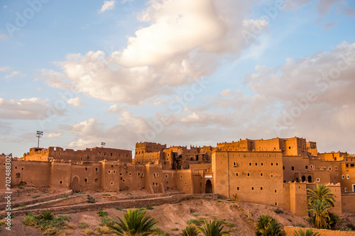 Panoramic view of Taourirt Kasbah, the traditional Moroccan clay fortress in the city of Ouarzazate, Morocco.  photo
