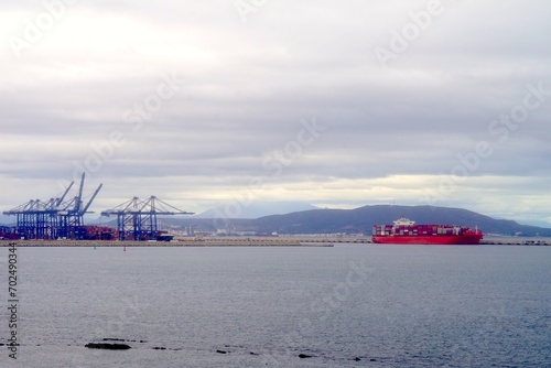 harbor cranes from the port of Algeciras and big container ship in the Bay of Algeciras, Bay of Gibraltar, Andalusia, Spain, trading, economy, logistics, transport