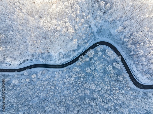 Winding country road near Gutenberg on the Swabian Alb in winter, there is snow in the forest, drone photo, Lenningen, Baden-Wuerttemberg, Germany, Europe