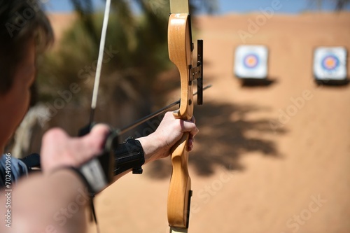 Woman doing archery in the desert of Dubai, United Arab Emirates, Asia photo