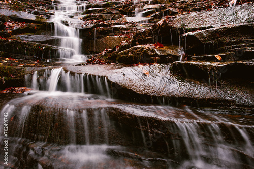 A waterfall cascades down dark rock along the Cumberland Trail in Rock Creek Gorge, Tennessee