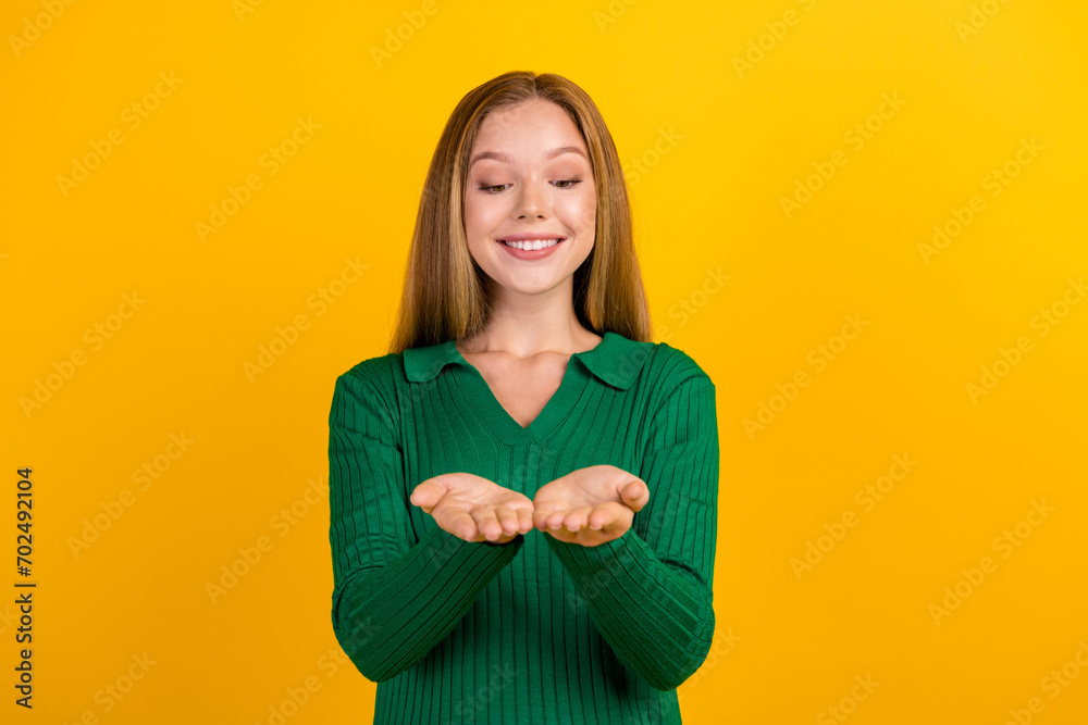 Fototapeta premium Portrait of cheerful person toothy smile hands palms hold empty space proposition isolated on yellow color background