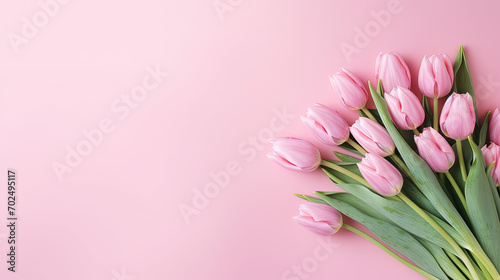 Bouquet of pink tulips on a pink background with copy space © Francescozano