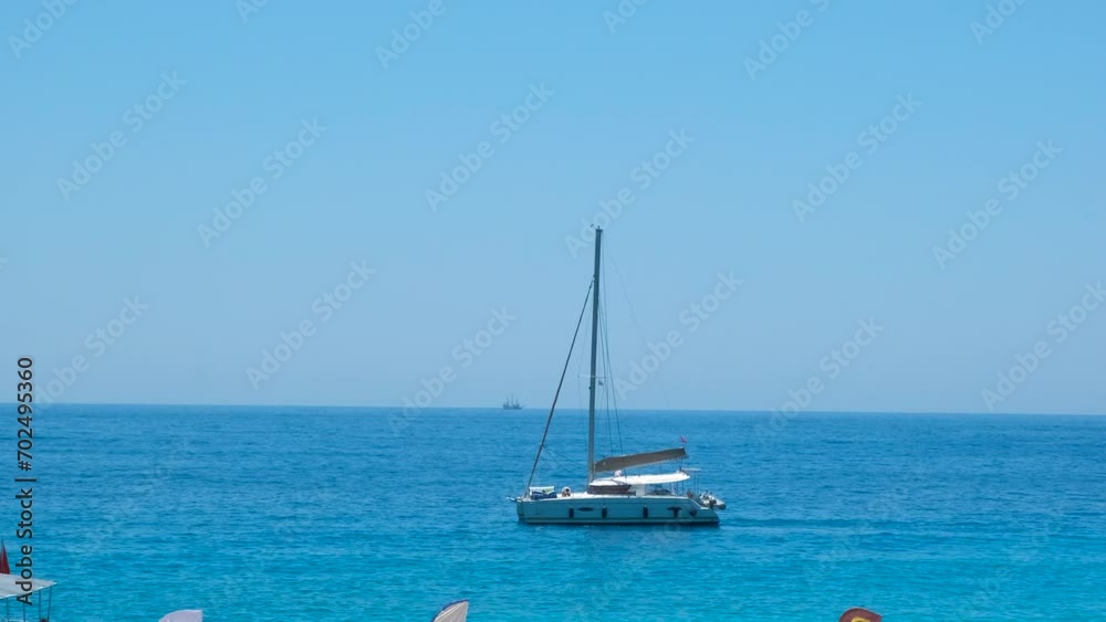Yacht without sails in island. A motor boat without sails floating in sunny blue sea water. A concept of sea weekend during summer. Yacht without sails in island. A motor boat without sails floating in sunny blue sea water. A concept of sea weekend during summer.