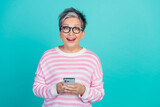 Photo of funny impressed woman dressed pink pullover communicating modern gadget empty space isolated teal color background