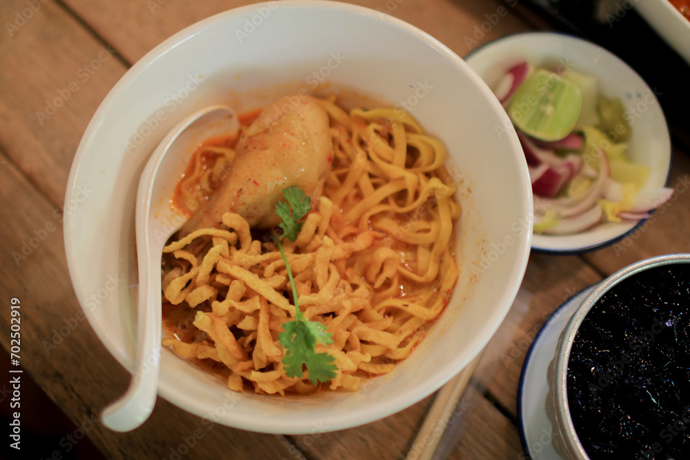 Khao Soi with chicken. Northern of Thailand Style Curry Noodle Soup with Chicken and seasoning. Spicy food.