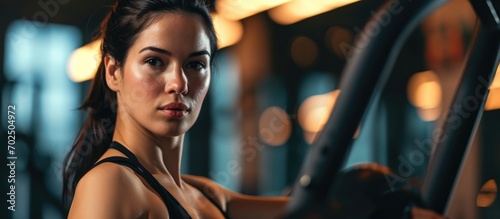 Gorgeous dark-haired woman exercising at gym. photo