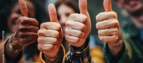 Diverse group showing thumbs up as approval for success, support, or good news.