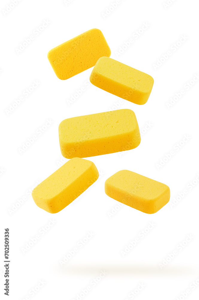 Falling yellow sponge isolated on white Falling yellow sponge isolated on white