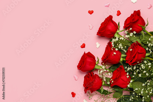 Red roses with gypsophila flowers and hearts on pink background. Valentine's day concept