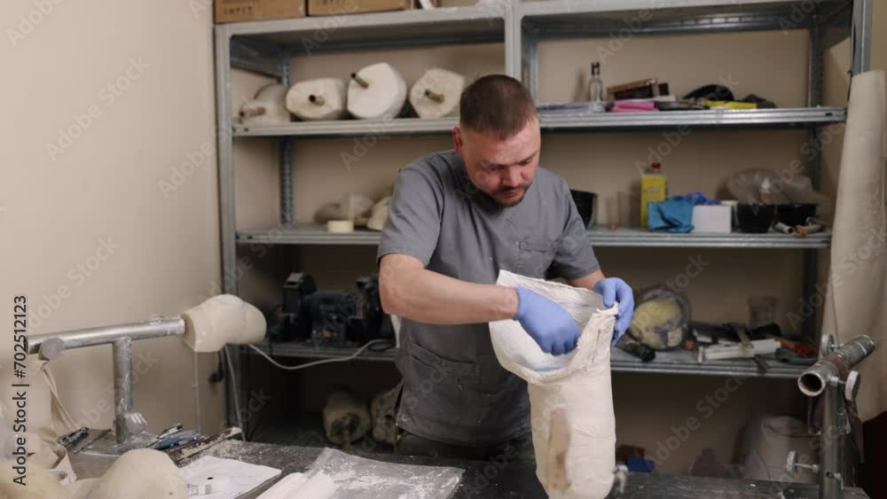 Plaster model, Professional workspace, Plaster designs. In professional studio, man creates plaster model for hip disarticulation prosthetic leg mold.