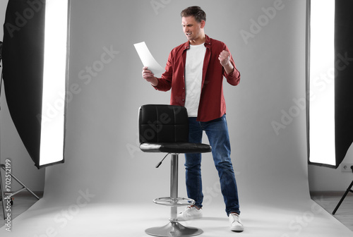 Casting call. Emotional man with script performing in studio