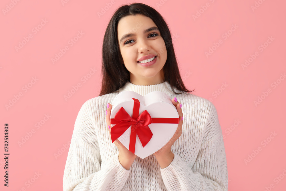 Beautiful young woman with gift for Valentine's day on pink background Beautiful young woman with gift for Valentine's day on pink background